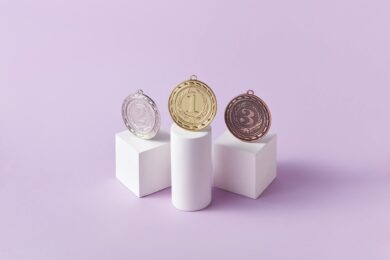 medals on pedestals on pink studio background